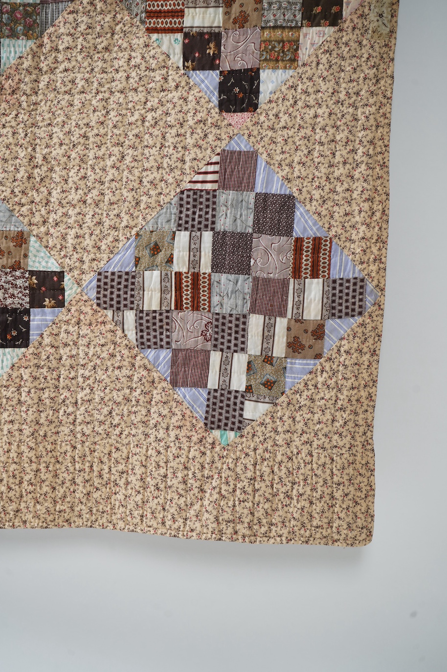 An American Kentucky 1865 (Civil War) block strip, ‘postage stamp’ hand quilted bedcover. Made from a large selection of highly fashionable madder dyed printed cottons of the day, as large concentric diamond shaped strip